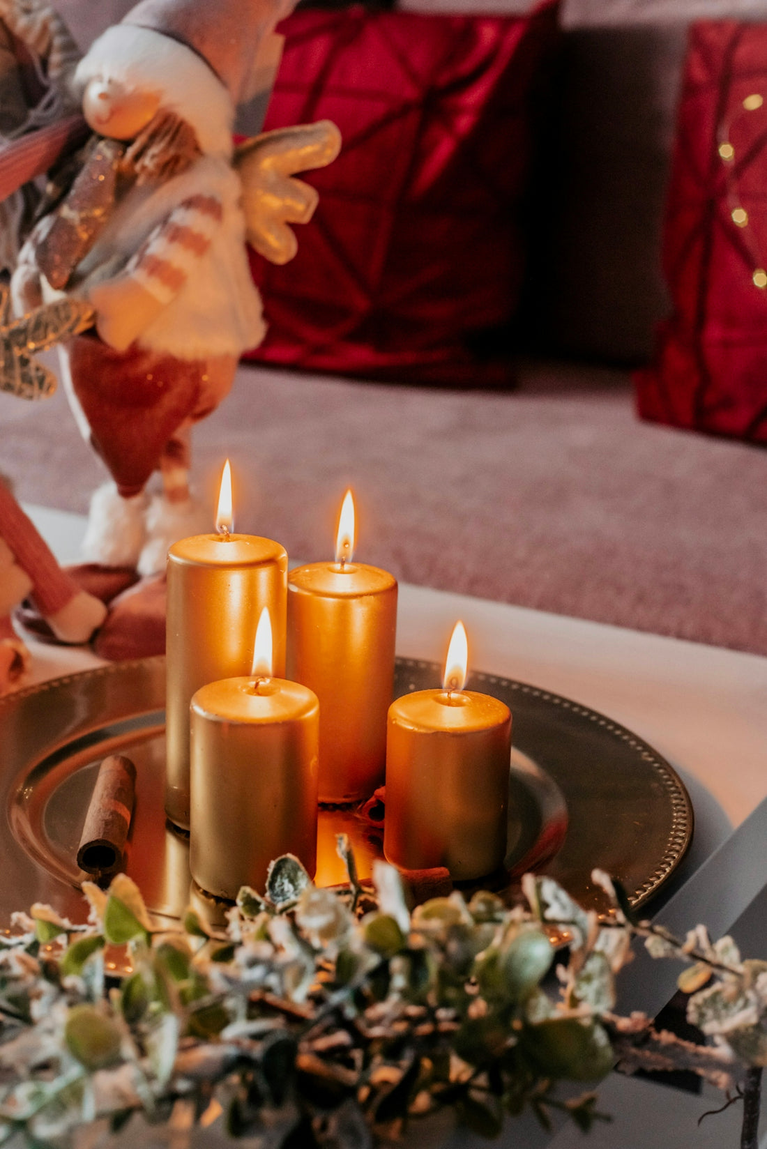 A table topped with candles and christmas decorations