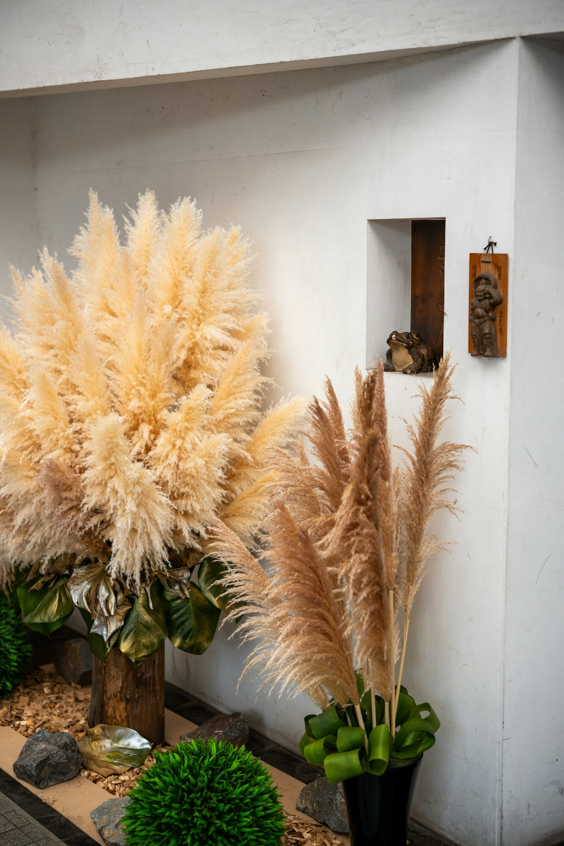 Tall dried pampas grass arrangements with decorative plants
